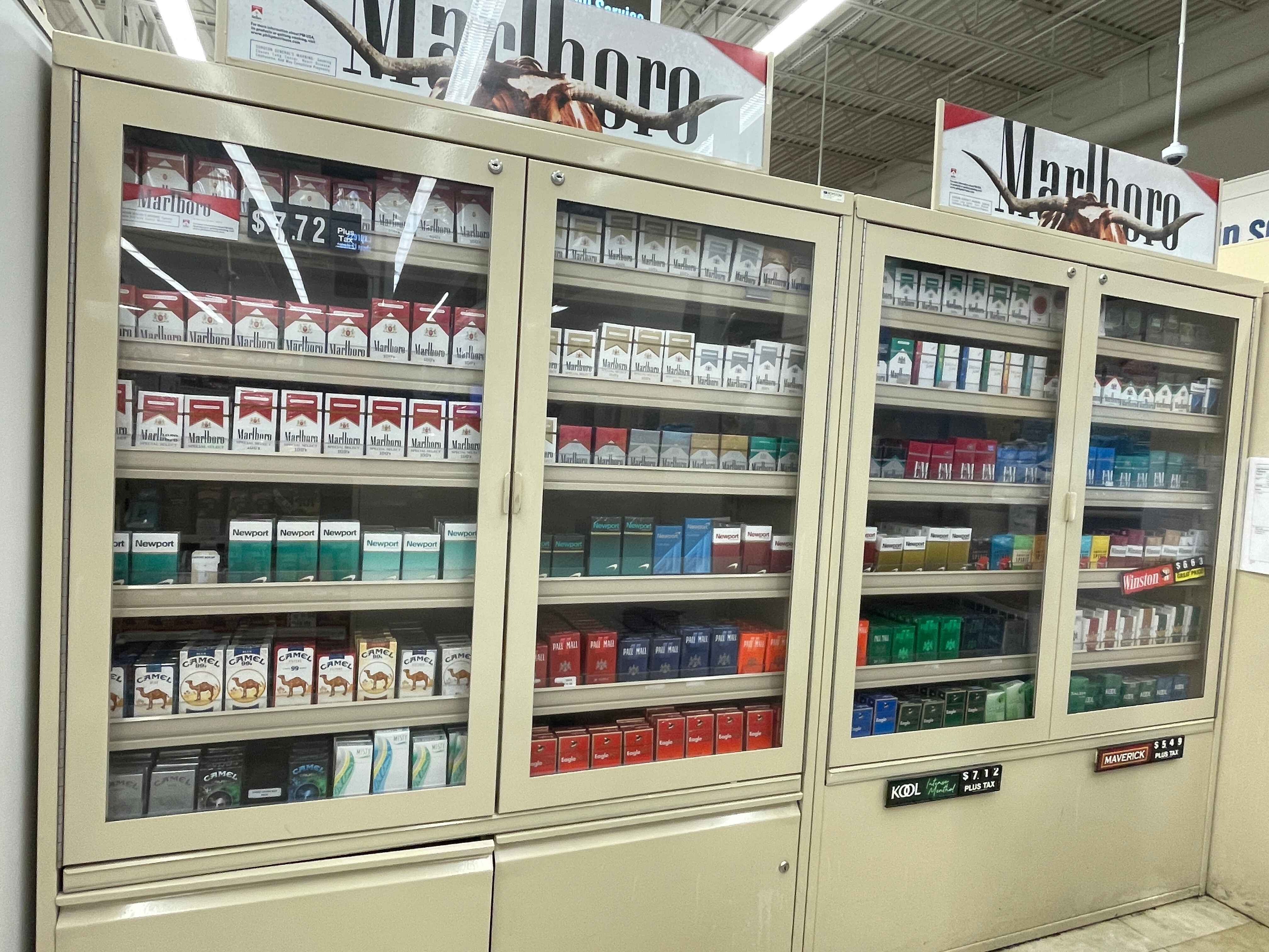 Display case with assorted cigarette packs and Marlboro advertisements