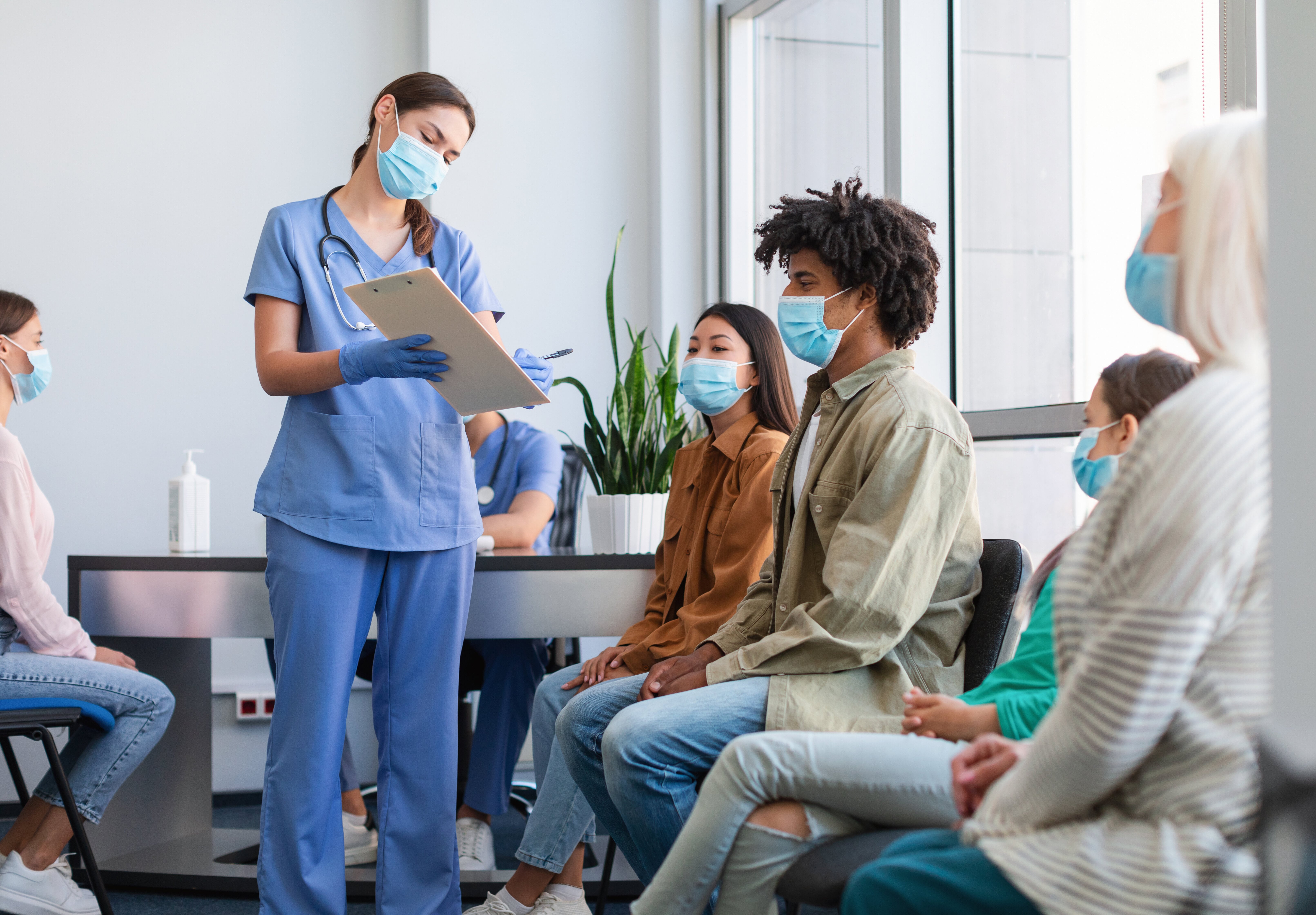 nurse explaining something to patient in clinic 