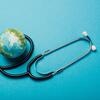 A small globe with a stethoscope wrapped around it on a blue background.