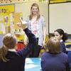 Child raising their hand in school